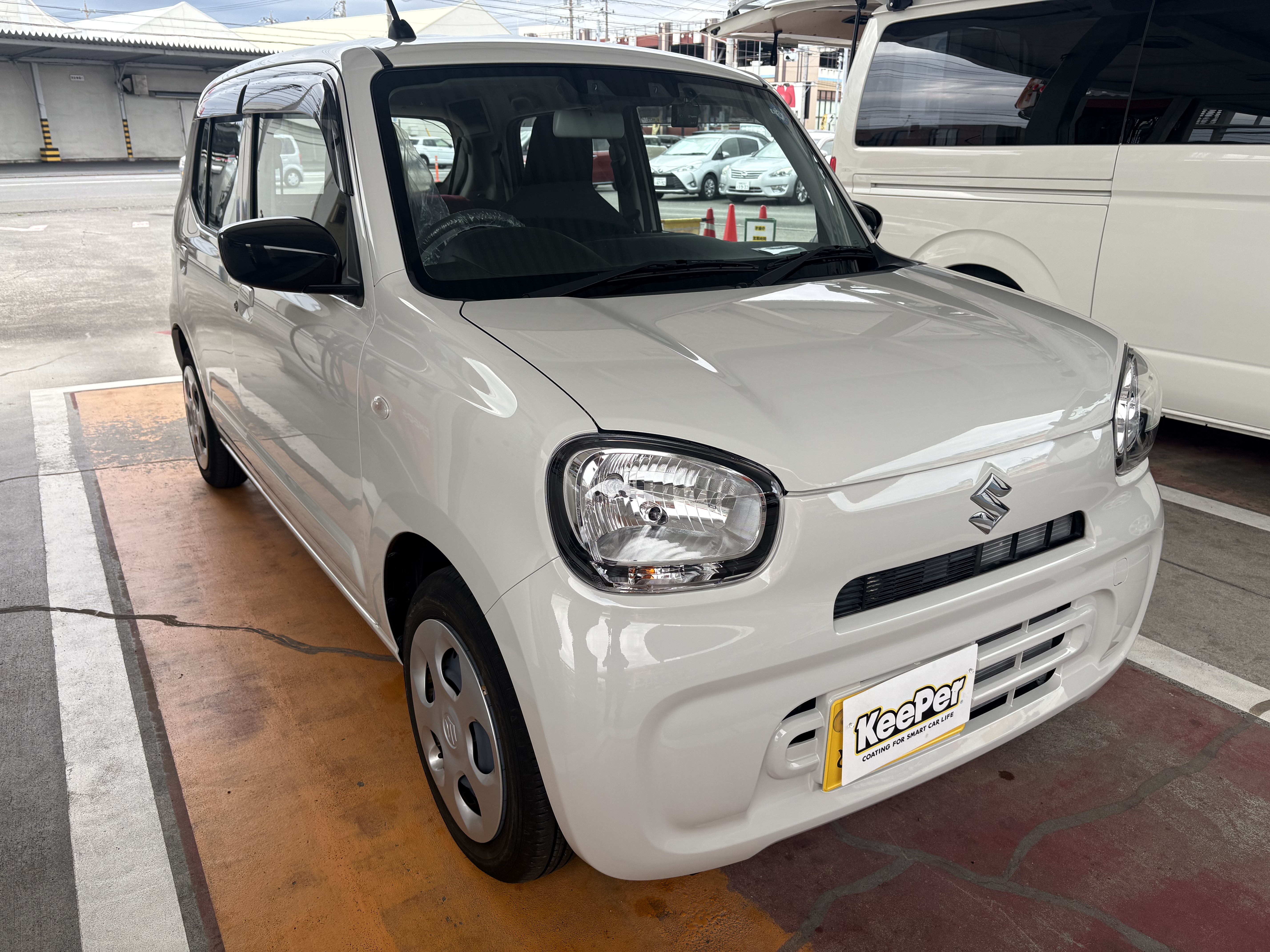 白いスズキ/アルトにクリスタルキーパーを施工した後のツヤのあるボディ