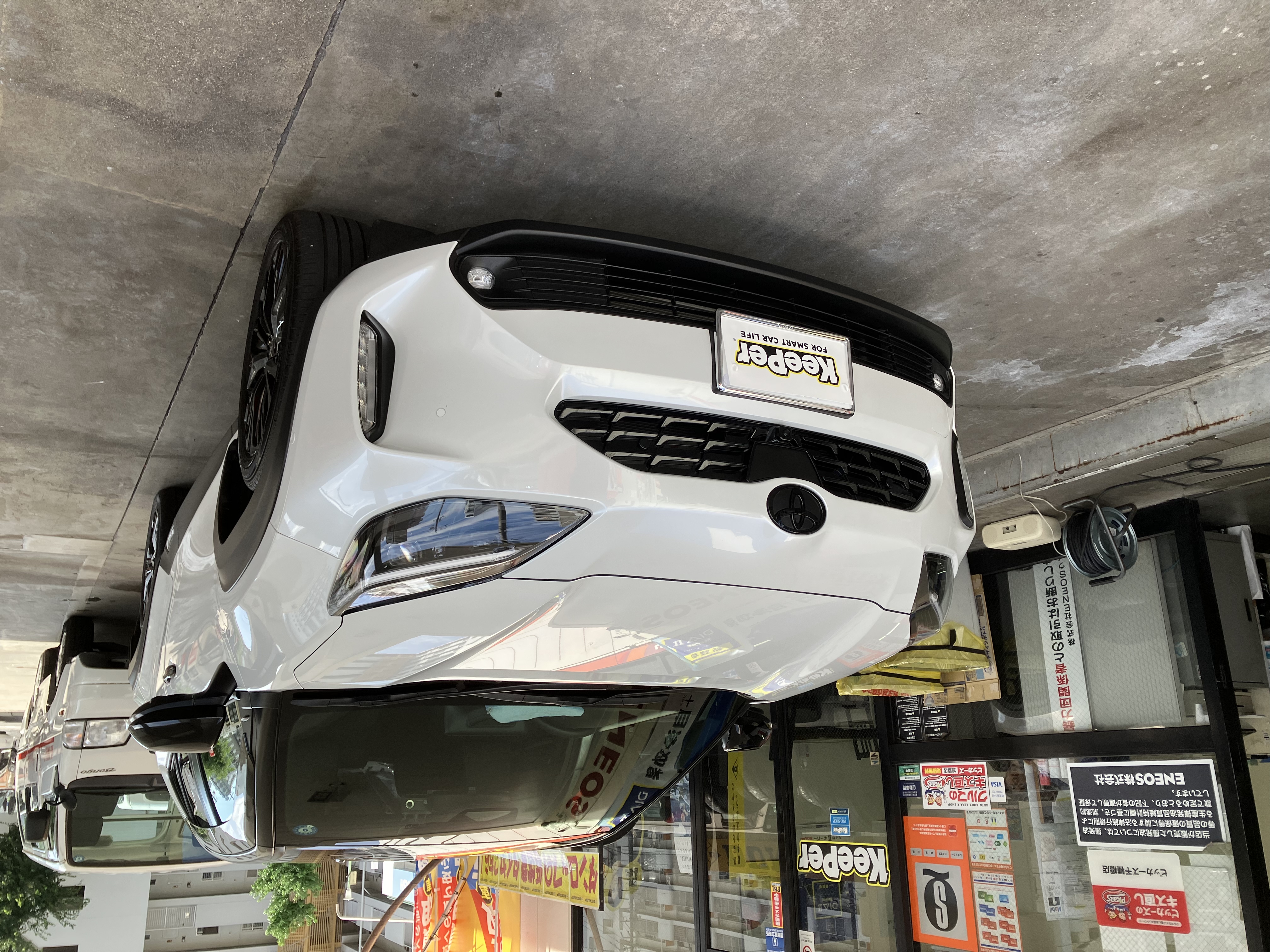 白いトヨタ ヤリスクロスにクリスタルキーパーを施工した後のツヤのあるボディ